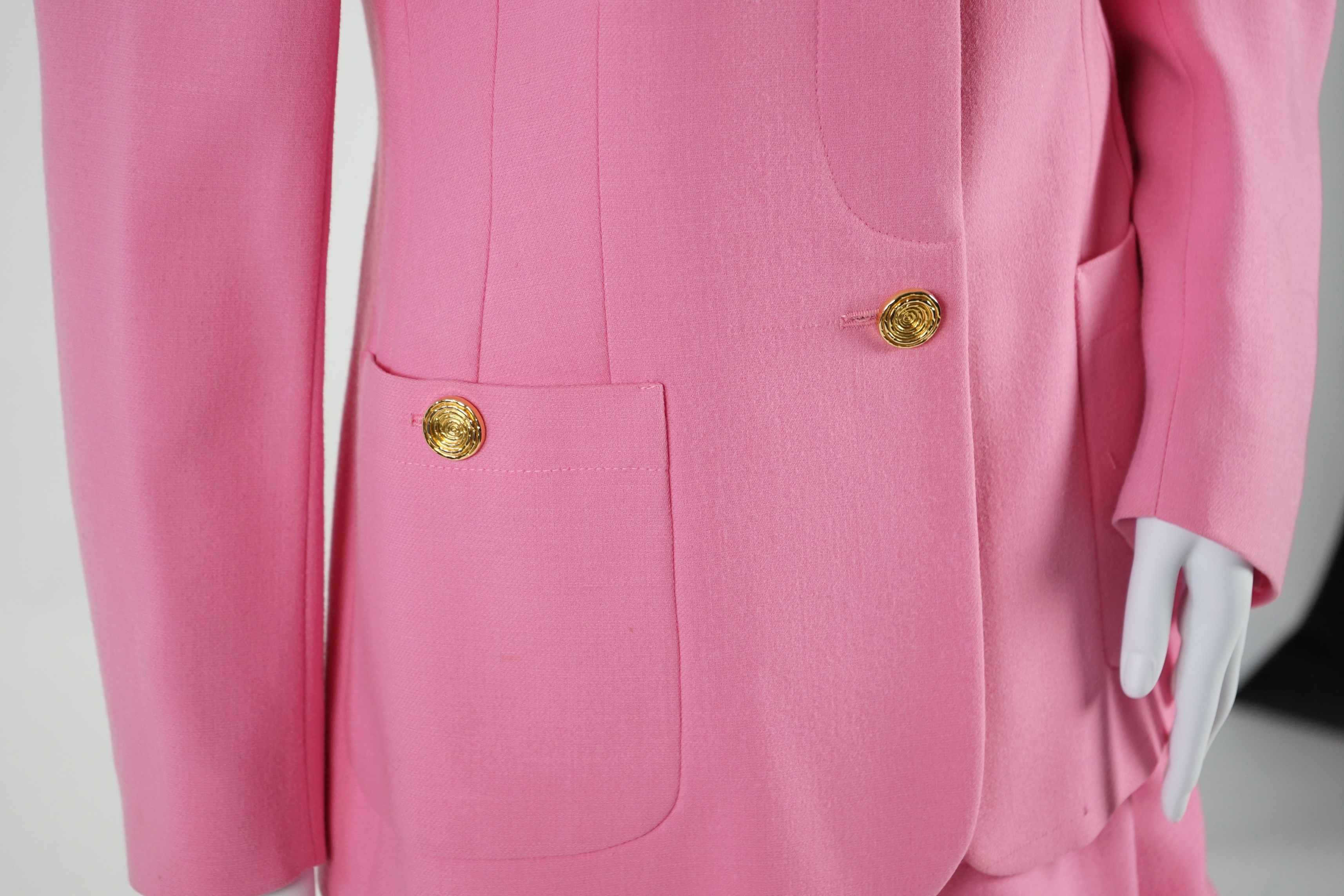 A pink Escada suit with a silk blouse top. Proceeds to Happy Paws Puppy Rescue